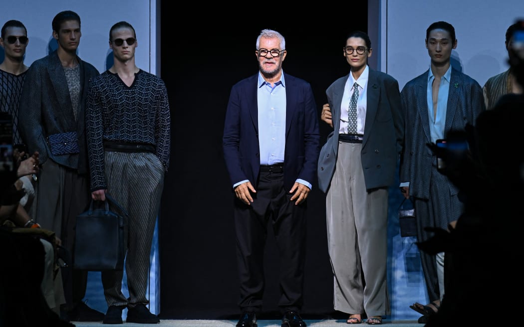 Head of the Men's Style Office of Armani Group, Pantaleo Dell'Orco, stands with models at the end of the Giorgio Armani collection show at Milan's Fashion Week Menswear Spring / Summer 2026, in June 2025, in Milan.