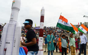 Students wave Indian national flags as the Indian Space Research Organisation's (ISRO) Chandrayaan-2 (Moon Chariot 2), with on board the Geosynchronous Satellite Launch Vehicle (GSLV-mark III-M1), has been launched in Sriharikota in the state of Andhra Pradesh on July 22, 2019.