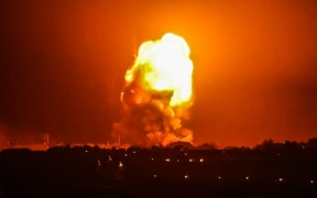 Fire billows from Israeli air strikes in Rafah, in the southern Gaza Strip, on May 11, 2021.