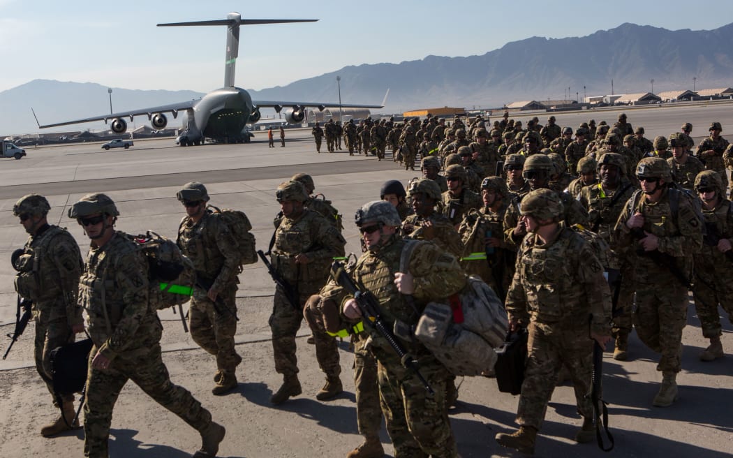 BAGRAM AIR BASE, AFGHANISTAN - MAY 11: U.S. Army soldiers from the 101st Airborne Division march from the back of a C-17 cargo plane May 11, 2013 at Bagram Air Base, Afghanistan.