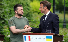 President of Ukraine Volodymyr Zelenskyy (L) shakes hands with President of the French Republic Emmanuel Macron during a joint press conference, Kyiv, capital of Ukraine on 16 June, 2022.