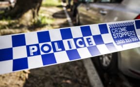 New South Wales (NSW) police tape can be seen across a road near the Russian consulate in Sydney on September 1, 2025. New South Wales Police said they were called to the Russian consulate after reports that an unauthorised vehicle was parked in the driveway. Officers attempted to speak to the driver, who then allegedly "drove his vehicle into the gates of the property," police said in a statement. (Photo by DAVID GRAY / AFP)