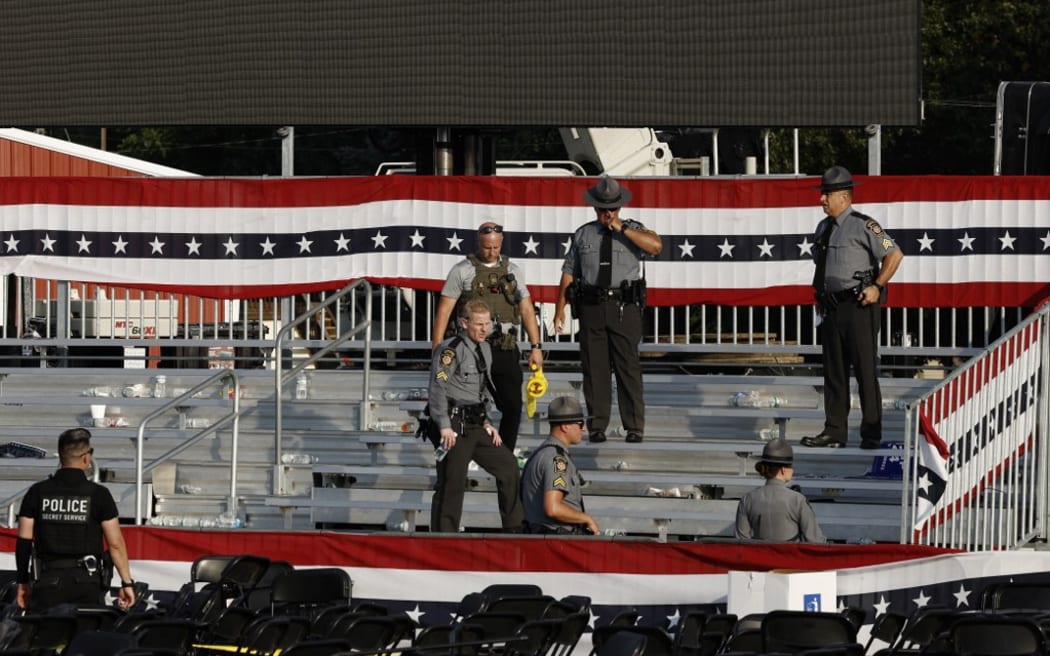 BUTLER, PENNSYLVANIA - JULY 13: Law enforcement agents stand near the stage of a campaign rally for Republican presidential candidate former President Donald Trump on July 13, 2024 in Butler, Pennsylvania. According to Butler County District Attorney Richard Goldinger, the suspected gunman is dead after injuring former President Trump, killing one audience member and injuring at least one other.   Anna Moneymaker/Getty Images/AFP (Photo by Anna Moneymaker / GETTY IMAGES NORTH AMERICA / Getty Images via AFP)