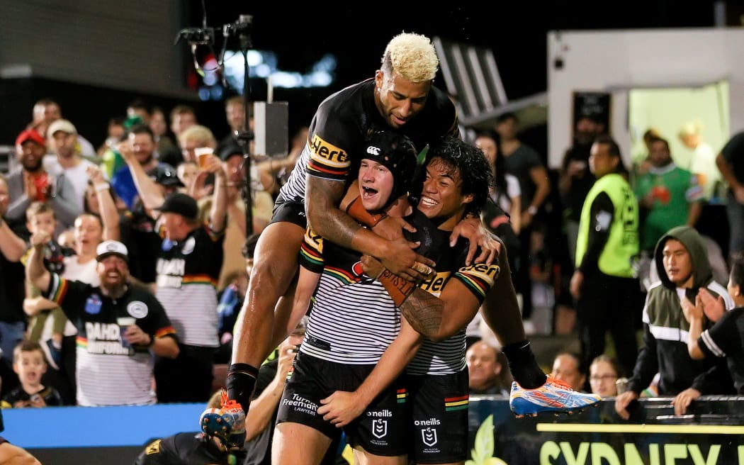 Matt Burton of the Panthers celebrates scoring a try.