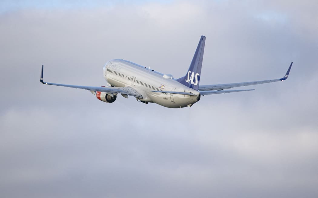 SAS Scandinavian Airlines Boeing 737-800 aircraft as seen during taxiing, rotation, take off and fly phase while departing from Amsterdam Schiphol AMS EHAM. The B738 passenger jet airplane passes in front of a control tower during as it is taking off from Polderbaan runway, the airplane has the registration LN-RRH and the name Freja Viking. SAS is the flag airline carrier of Denmark, Norway and Sweden, the airline has a fleet size of 180 planes and is member of Star Alliance aviation group. According to European media SAS announced 4000 flight cancellations this summer tourist season due to staff shortages and increased demand, 2 years after the Covid-19 Coronavirus pandemic measures relaxed and people want to travel and visit places for holidays. Amsterdam, the Netherlands on April 27, 2022 (Photo by Nicolas Economou/NurPhoto) (Photo by Nicolas Economou / NurPhoto / NurPhoto via AFP)