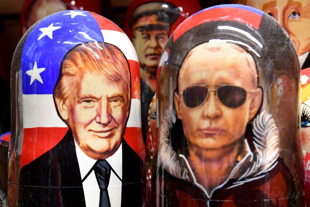 Traditional Russian wooden nesting dolls, Matryoshka dolls, depicting Russia's President Vladimir Putin and US President Donald Trump are displayed for sale in Saint Petersburg on August 7, 2025. The Kremlin said on August 7, 2025 that a milestone summit between Donald Trump and Vladimir Putin to resolve the conflict in Ukraine was set for the "coming days". The Russian leader named the United Arab Emirates (UAE) as a potential location for the Trump summit, but ruled out a meeting with Ukraine's Zelensky as conditions for such weren't met yet. (Photo by Olga MALTSEVA / AFP)