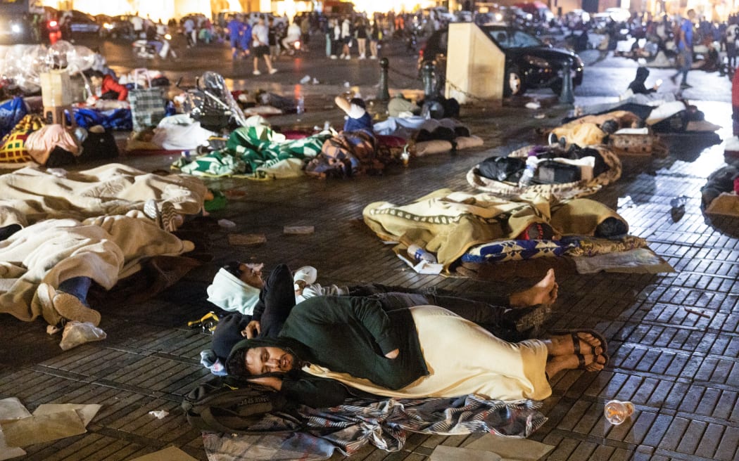 Residents take shelter ouside at a square following an earthquake in Marrakesh on September 9, 2023. Nearly 300 people were killed after a powerful earthquake rattled Morocco on September 8 night, according to a preliminary government count, with Marrakesh residents reporting "unbearable" screams followed the 6.8-magnitude quake. (Photo by Fadel SENNA / AFP)