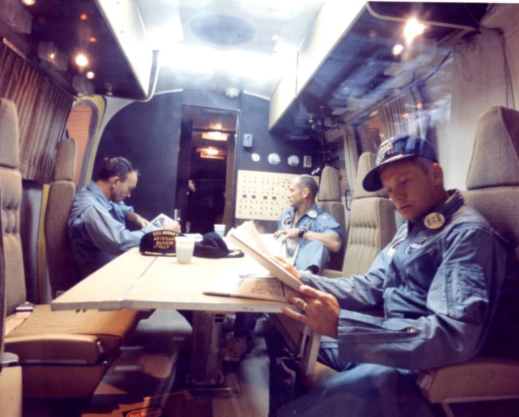 Michael Collins, Buzz Aldrin and Neil Armstrong relax after their moon landing