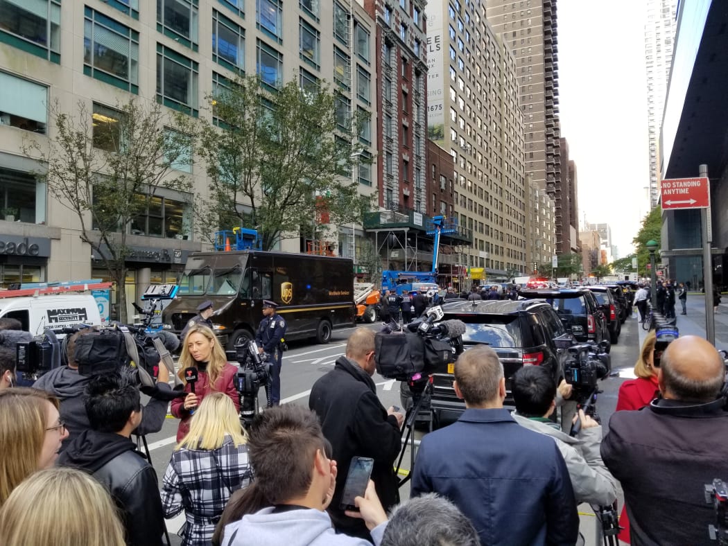 Police officers take security measures in front of the Time Warner Building where a suspected explosive device was found in the building after it was delivered to CNN's New York bureau in New York.