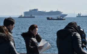 The Diamond Princess cruise ship (top,C) is seen off the port of Yokohama on February 5, 2020. - At least 10 people on a cruise ship quarantined off the coast of Japan have tested positive for the new coronavirus, Japan's health minister said on February 5.