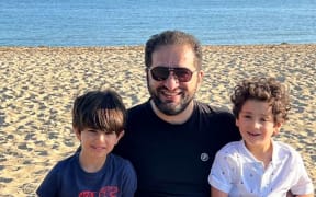 Fadi Hamdan, with his twin sons, who are waiting for citizenship.