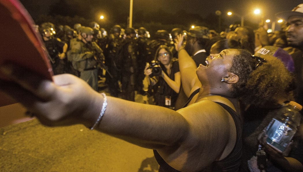 Gina Key-Conrad pleads with Baton Rouge police in riot gear as they move in on the protesters over the Alton Sterling shooting on July 9, 2016 in Baton Rouge, Louisiana.
