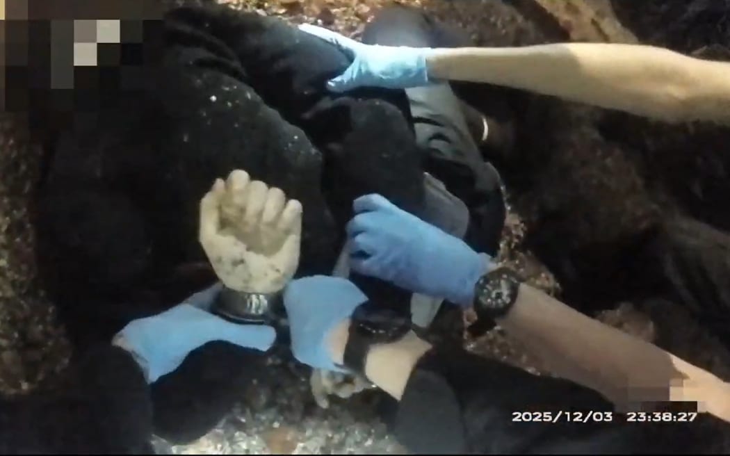 This screen grab from bodycam video taken on December 3, 2025 and released by Hampshire & Isle of Wight Constabulary to AFP on June 2, 2026 shows 18-year-old student Henry Nowak being handcuffed by police before his death, following a false claim of racial abuse, in Southampton, south England. UK police released footage of a dying student falsely accused of racially abusing a British Sikh man, prompting far-right leader Nigel Farage on June 2, 2026 to attack diversity policies in policing.
