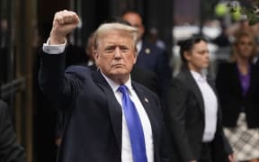 Former US President and Republican presidential candidate Donald Trump holds up a fist as he arrives back at Trump Tower after being convicted in his criminal trial in New York City, on May 30, 2024. A panel of 12 New Yorkers were unanimous in their determination that Donald Trump is guilty as charged -- but for the impact on his election prospects, the jury is still out. The Republican billionaire was convicted of all 34 charges in New York on May 30, 2024, and now finds himself bidding for a second presidential term unsure if he'll be spending 2025 in the Oval Office, on probation or in jail. (Photo by TIMOTHY A. CLARY / AFP)