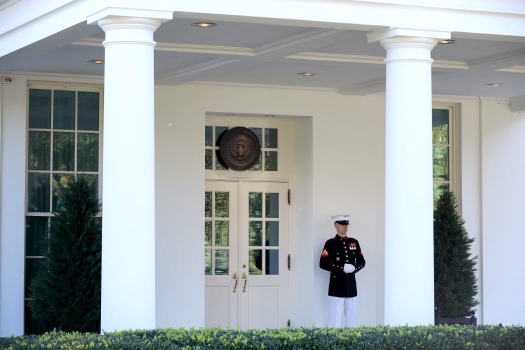 WASHINGTON, DC - OCTOBER 07: A U.S. Marine stands watch outside the doors of the White House West Wing October 07, 2020 in Washington, DC. According to the White House, President Donald Trump was in the Oval Office Wednesday afternoon, three days after returning from Walter Reed National Military Medical Center after tested positive and being treated for COVID-19.   Chip Somodevilla/Getty Images/AFP (Photo by CHIP SOMODEVILLA / GETTY IMAGES NORTH AMERICA / Getty Images via AFP)