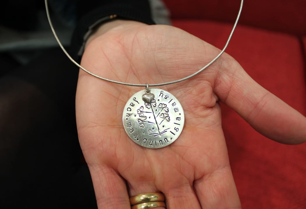 A photo of a special necklace belonging to Karlena Kelliher.It shows the names of all her children, including her daughter, Mae, who was stillborn.
