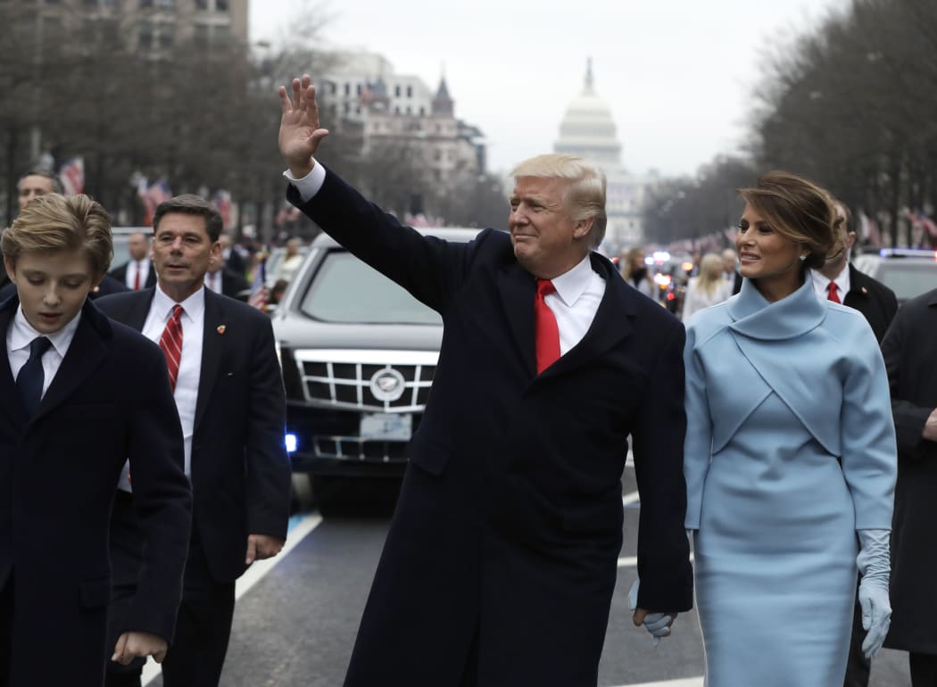 President Donald Trump and Melania Trump walking part of the way during the inaugural parade to the White House.