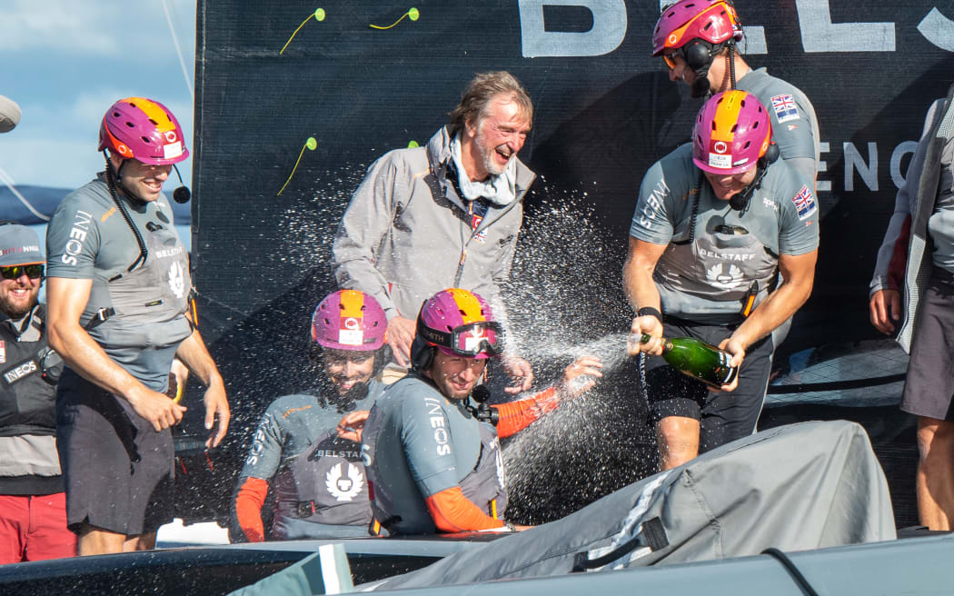 Ben Ainslie is sprayed with champagne by Britannia team-mates and owner Jim Ratcliffe (top centre).