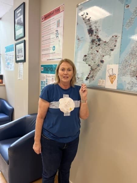Kath Cross puts up a pin with her transplant number on a map before leaving the Hearty Towers rehab centre in Greenlane, Auckland.