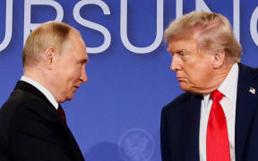 President Donald Trump and Russian President Vladimir Putin look at each other during a press conference following their meeting to negotiate an end to the war in Ukraine, at Joint Base Elmendorf-Richardson, in Anchorage, Alaska, 15 August.