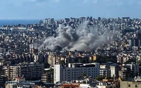 Thick smoke rises above the southern suburbs of Beirut after an Israel strike on September 20, 2024. The strike on Hezbollah's stronghold in Lebanon's capital Beirut reportedly killed at least eight people and wounded dozens of others, with a source close to the movement saying a top military leader was dead. (Photo by AFP)