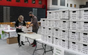 Poll workers check in a box of absentee ballots in Sun Prairie, Wisconsin, on 3 November 2020.