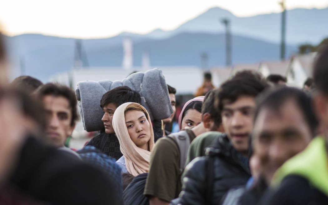 Migrants and refugees wait for a train heading to Serbia from the Greek-Macedonian border on November 5, 2015 AFP PHOTO / ROBERT ATANASOVSKI