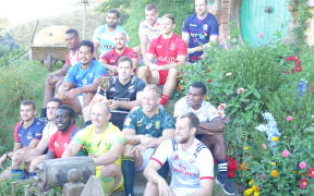 Sevens teams' captains pose for a photo at Hobbiton.