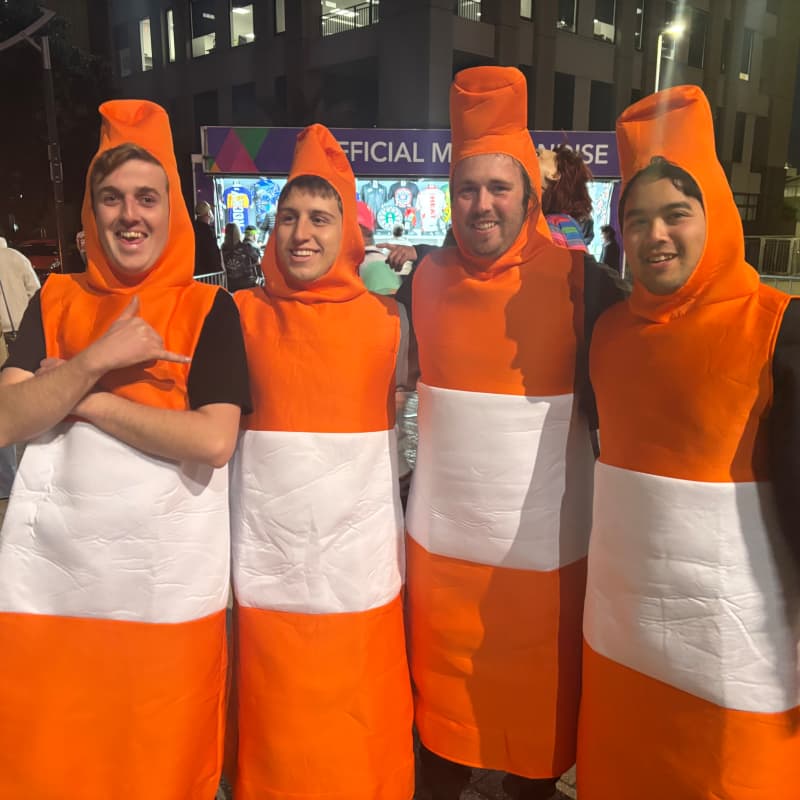 Four men dressed as roadcones.