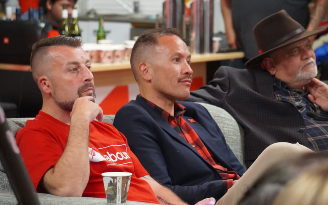 Tāmati Coffey and partner Tim Smith watch the results during Election Night 2023.