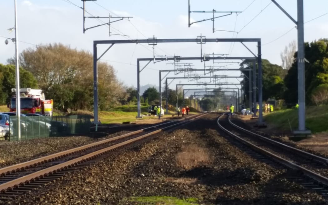 Emergency workers attend the scene where there have been reports of a body on the tracks.