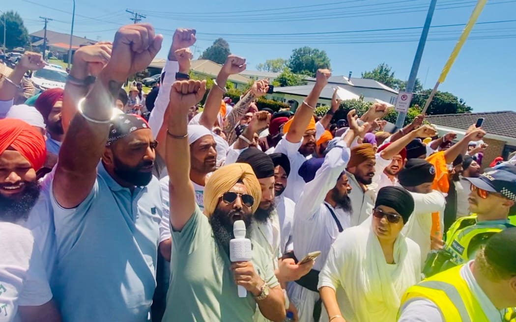 Sikh men rally after protesters blocked a religious procession in Tauranga on Saturday.