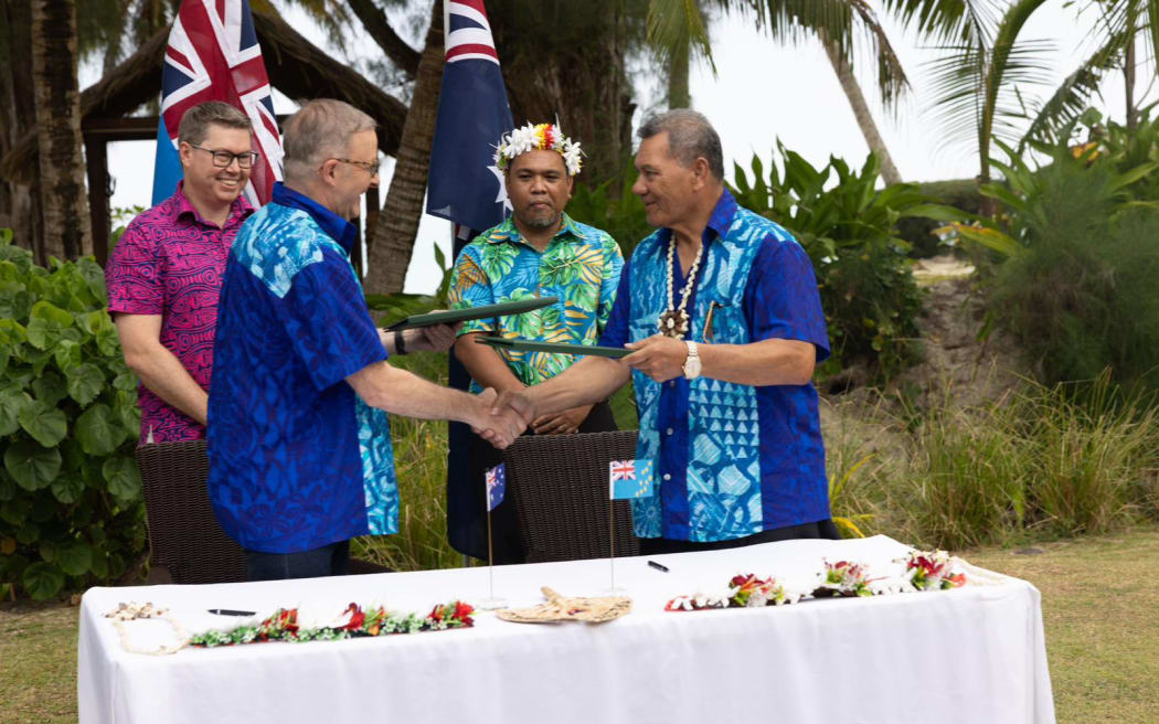 Australia and Tuvalu sign the Falepili Union treaty in Rarotonga: Australian PM Anthony Albanese, (front left) and Tuvalu PM Kausea Natano exchange the agreement. 10 November 2023
