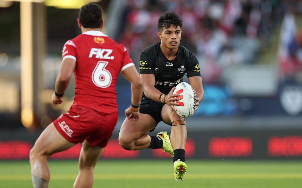 Keano Kini of the Kiwis is defended by Isaiah Iongi of Tonga during New Zealand Kiwis v Tonga XIII, round 3 of the Pacific Championships at Eden Park.