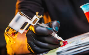 master tattoo artist prepares tools for tattooing