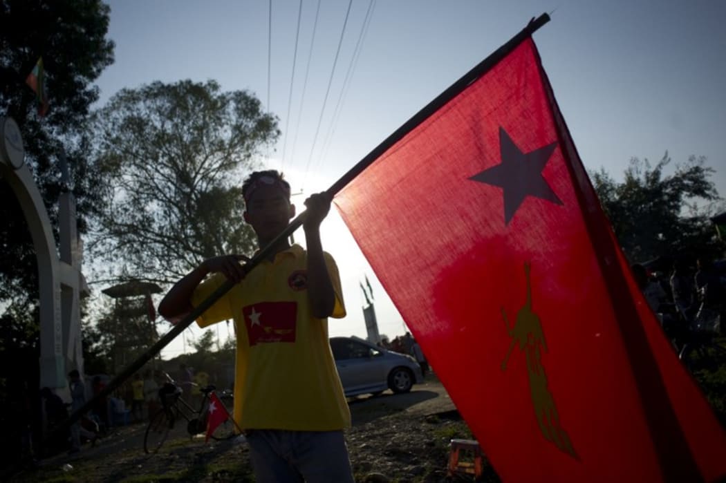 A National League for Democracy supporter holds the party flag (file photograph).
