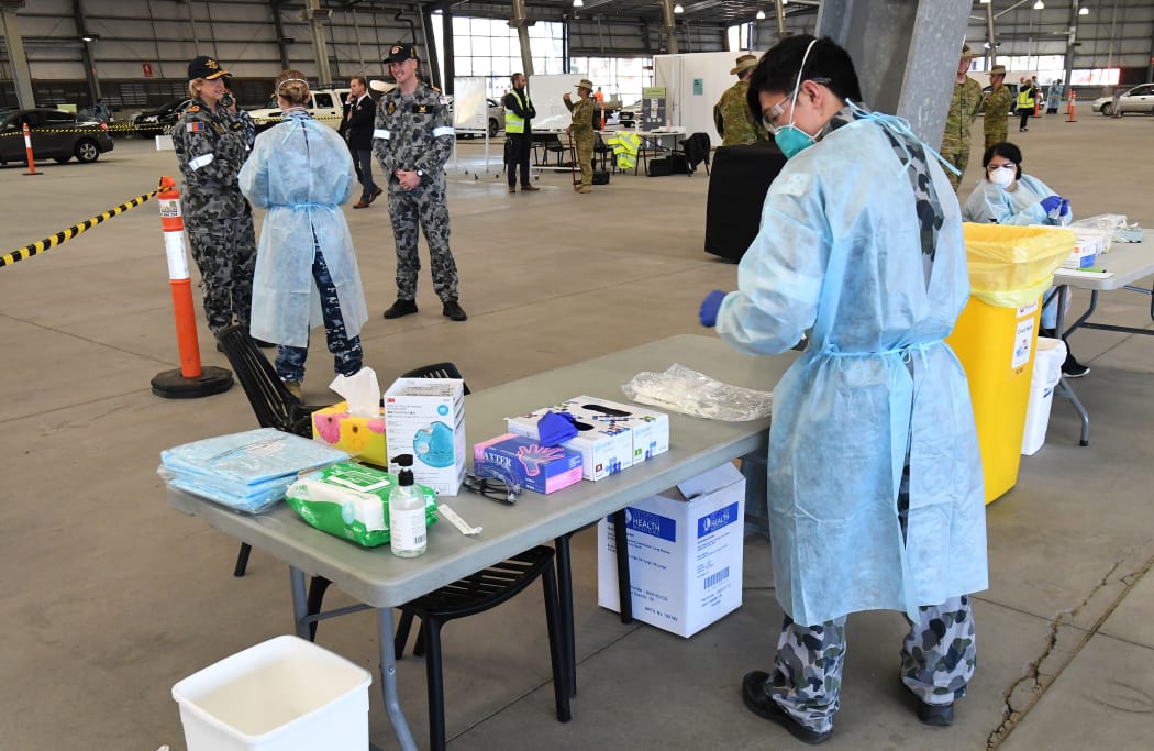 Surgeon General of the Australian Defence Force, Rear Admiral Sarah Sharkey (L), speaks to defence personnel manning a Covid-19 coronavirus drive-through testing station in Melbourne on June 29, 2020. The city has seen a resurgence in the virus.