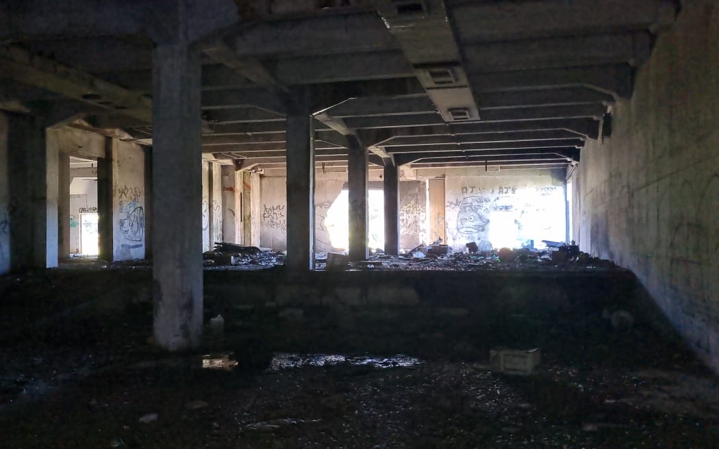 A derelict coolstores building on the banks of the Pātea River in Taranaki.