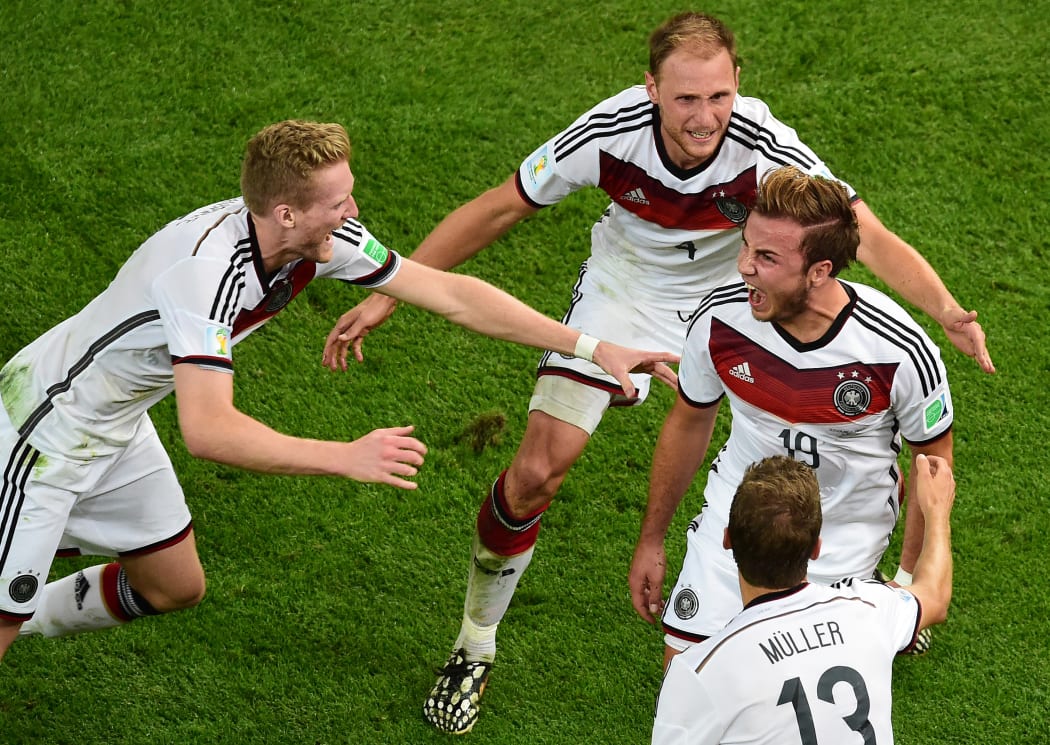 Germany's forward Mario Goetze (centre) celebrates with Andre Schuerrle, Benedikt Hoewedes and Thomas Mueller after the goal.