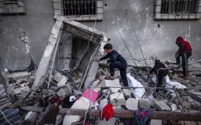 Children inspect the damage following Israeli bombardment in Rafah on the southern Gaza Strip on December 29, 2023, amid the ongoing battles between Israel and the Palestinian militant group hamas.
