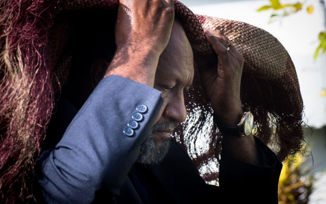 PM Charlot Salwai covers himself with a ceremonial red mat as he arrives at the State House to pay respects to President Baldwin Lonsdale.