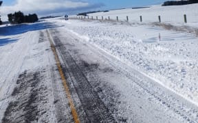 Strong winds are blowing snow onto the closed section of State Highway 87, near Clarks Junction this morning