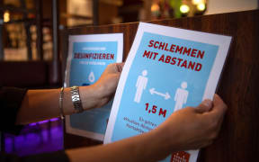 Stickers with hygiene regulations are hung up in a restaurant in Bremen, Germany, on 18 May, 2020.