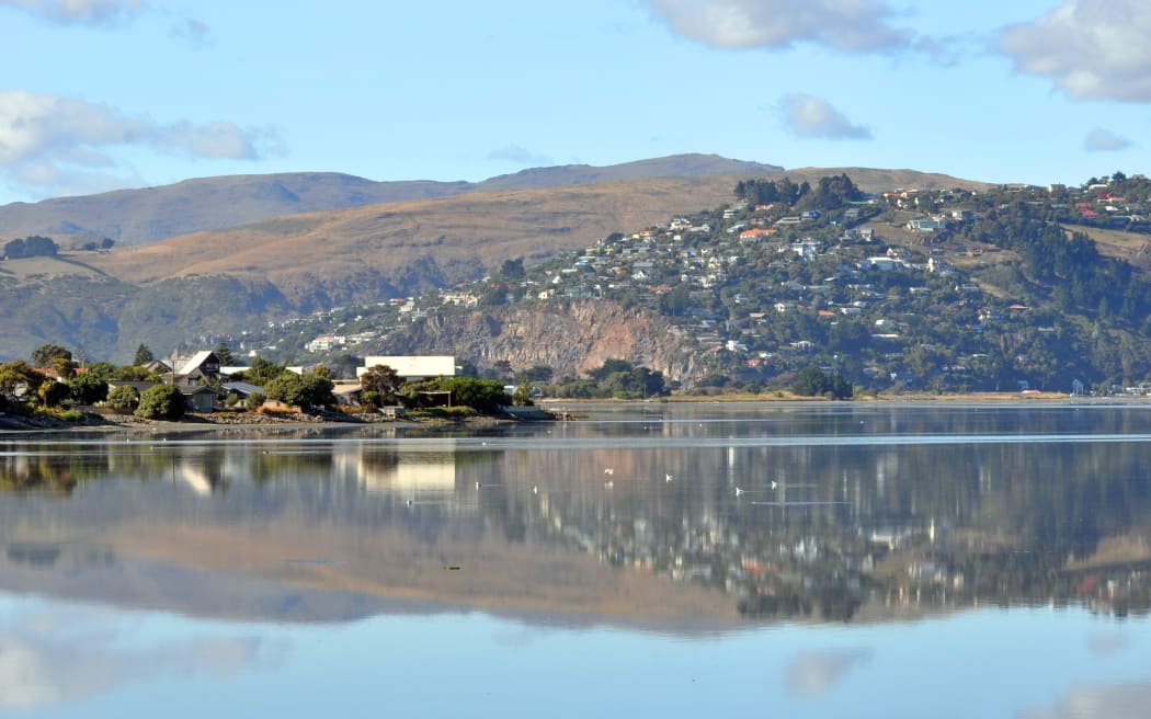 A panorama of Christchurch estuary in the foreground with the hill suburb of Redcliffs in the background.