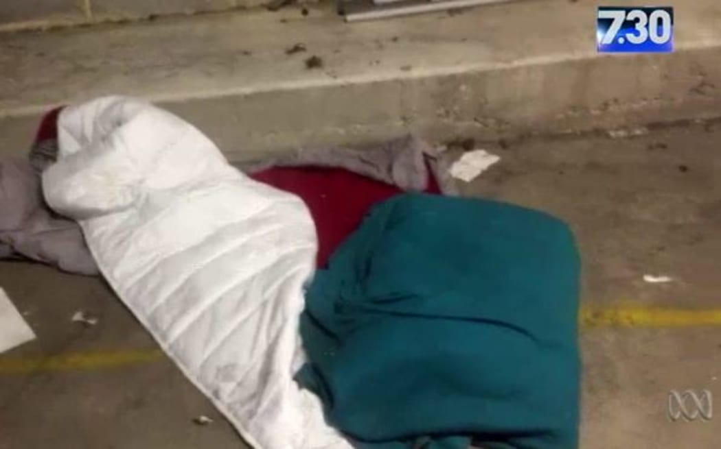 A screenshot from footage obtained by the ABC's 7.30 programme shows bedding underneath the Sydney Airport international terminal.