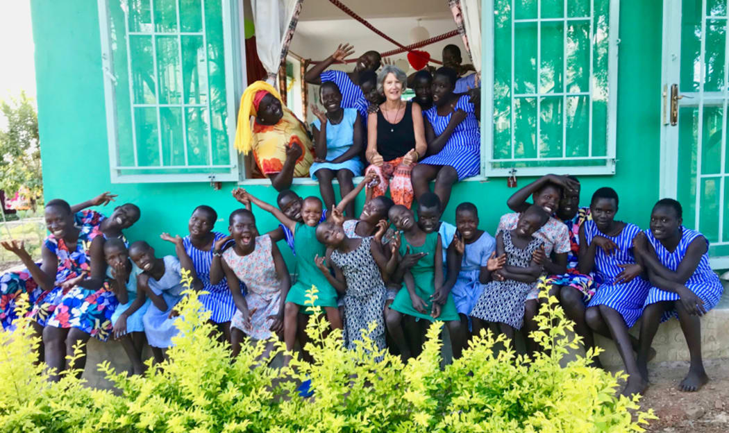 Jayne Bailey with some of the girls in front of the home.