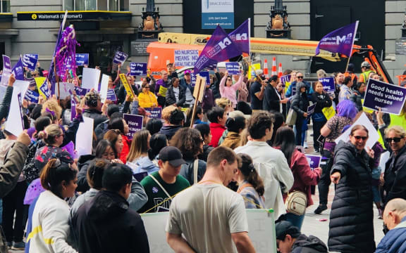 Nurses and healthcare assistants strike outside Britomart Station in Auckland.