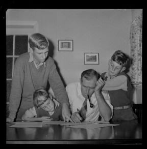 Mr M A Watts with his sons filling in census forms, 1956. Evening Post newspaper
