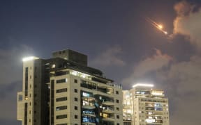 Rocket trails in the sky above the Israeli coastal city of Netanya amid a fresh barrage of Iranian missile attacks on 15 June, 2025.
