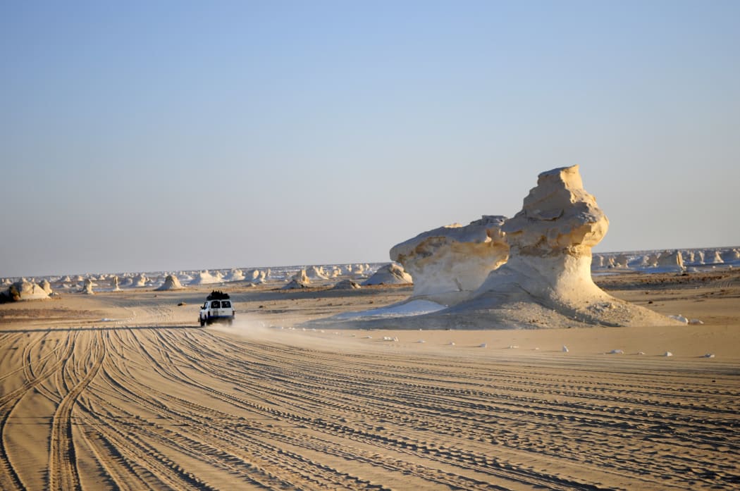 A photo taken on 4 September 2009 in Egypt's vast Western Desert shows a car driving in the White Desert near Farafra.